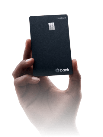 A hand holding a bank card
